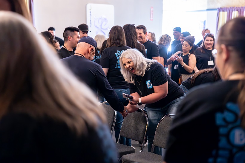 Coworkers high-fiving during a team-building workshop