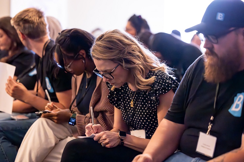 Workshop attendees taking notes during a leadership session