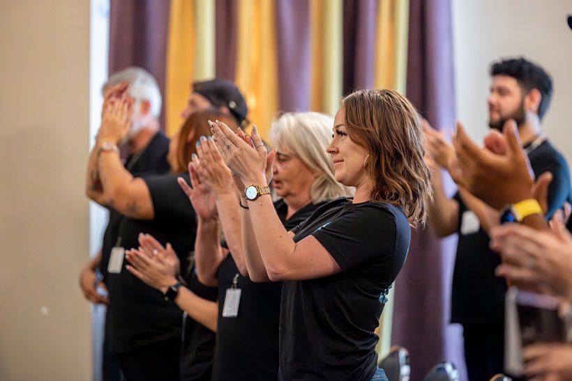 Team members applauding during an improv workshop