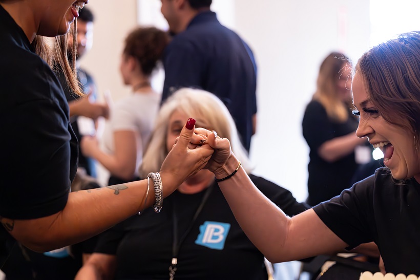 Two teammates connecting during a paired improv exercise
