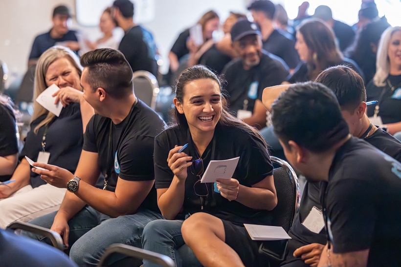 Corporate team laughing during a JesterZ improv workshop